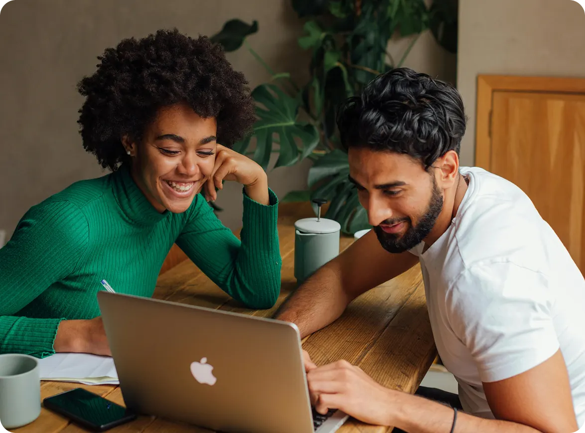 Independent Doers collaborating at a table with a laptop