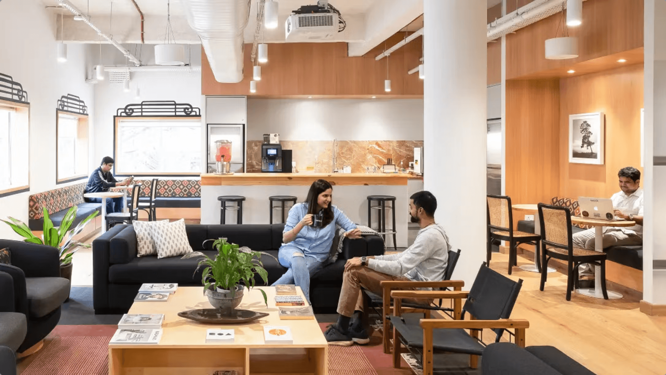 Modern WeWork coworking space with high ceilings, wooden accents, lounge areas, and coffee stations
