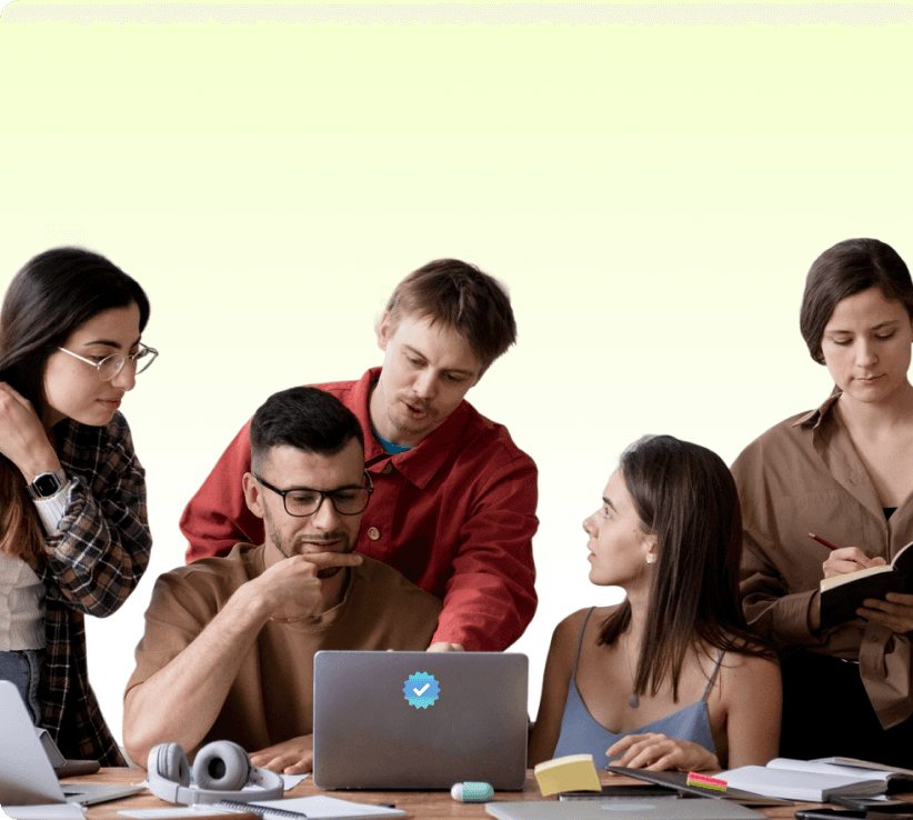 Team collaborating around a laptop